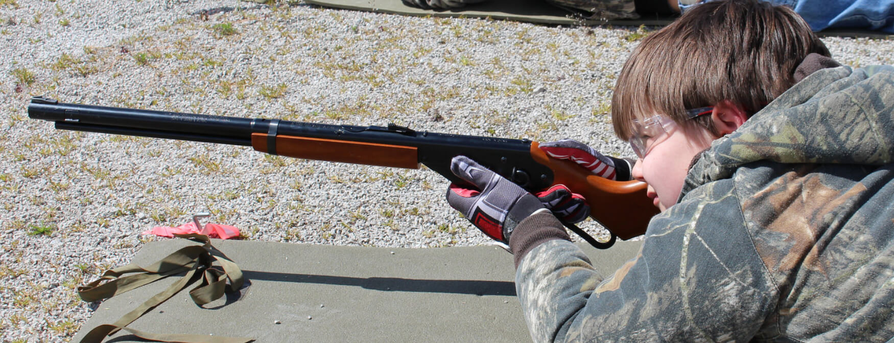 A Scout takes aim with a BB gun