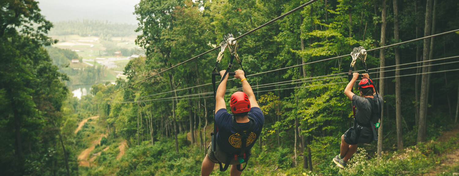 Scouts zip-line down a mountain