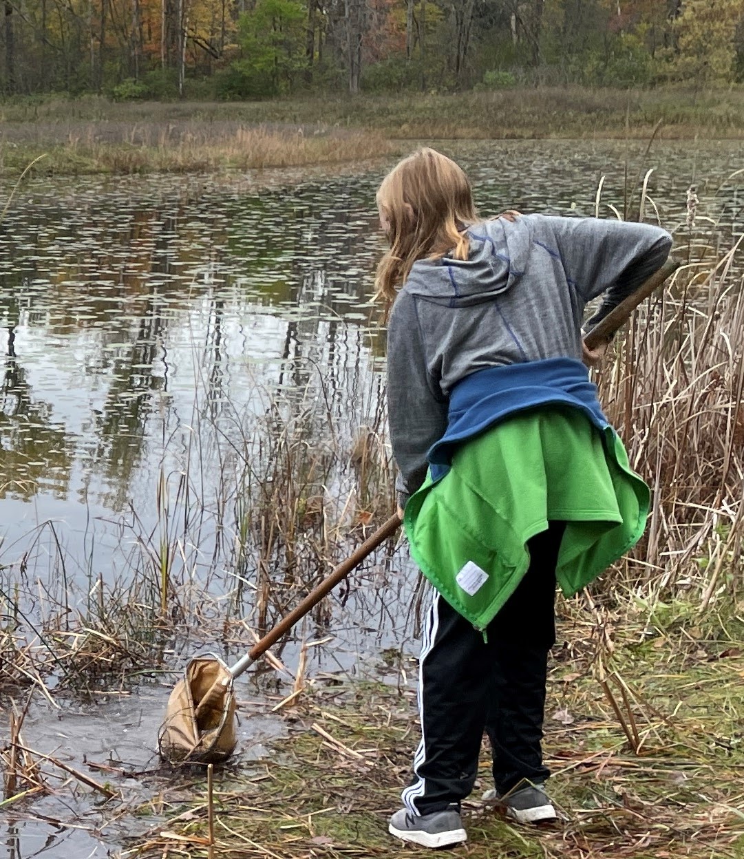 girl holding tadpoles