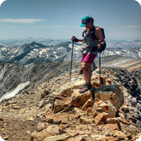 Photo for Dream Big Be Courageous, hiker on top of a rocky mountain