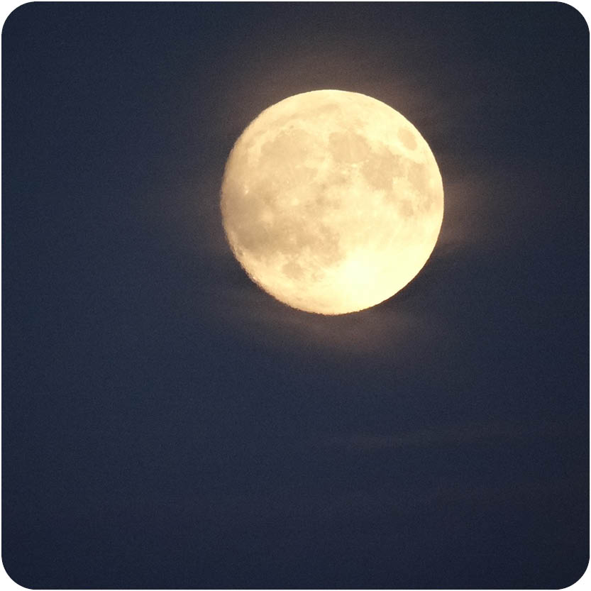 Full Moon in dark cloudy sky