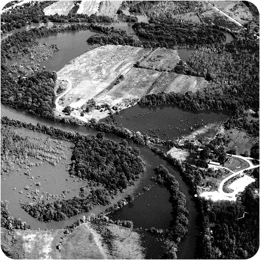 black and white historic photo of the CNC Properties during a flood