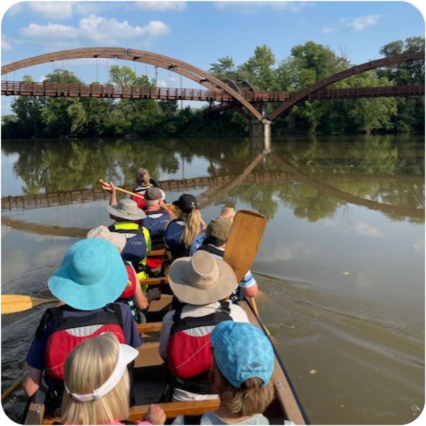 Voyageur Canoe Trip in front of the Tridge 3 sided bridge in Midland Michigan