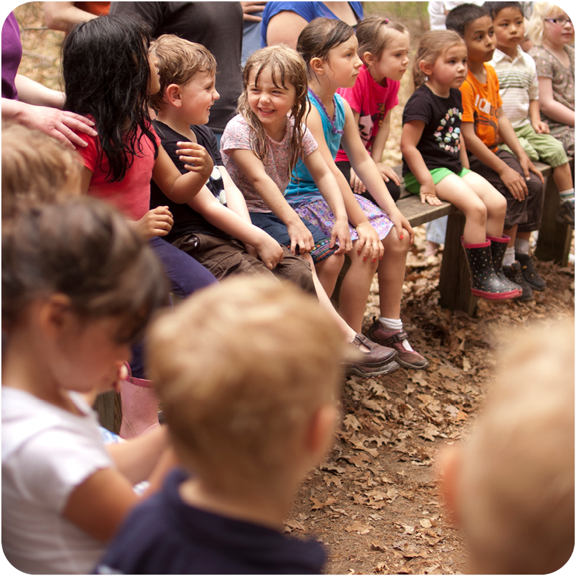 Story Hour - Group of Kids smiling and listening to speaker