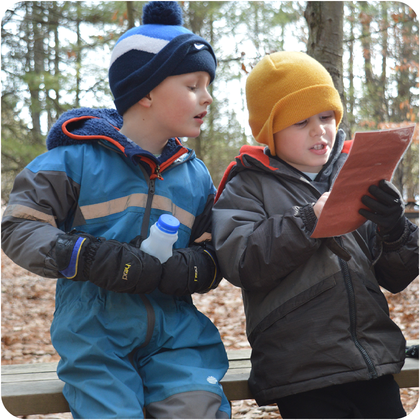 Story Hour - two boys reading outside