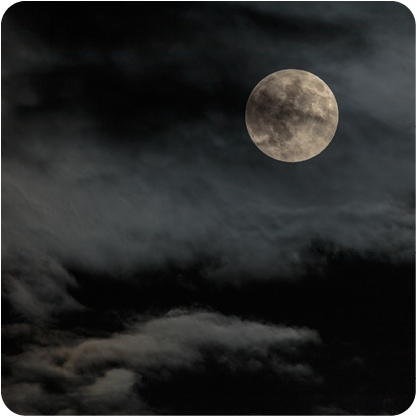 Full Moon in dark cloudy sky